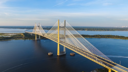 aerial photography of yellow bridge surrounded by body of water