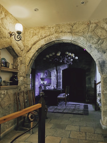 Photo of a Cellar with Stone Walls and a Chandelier